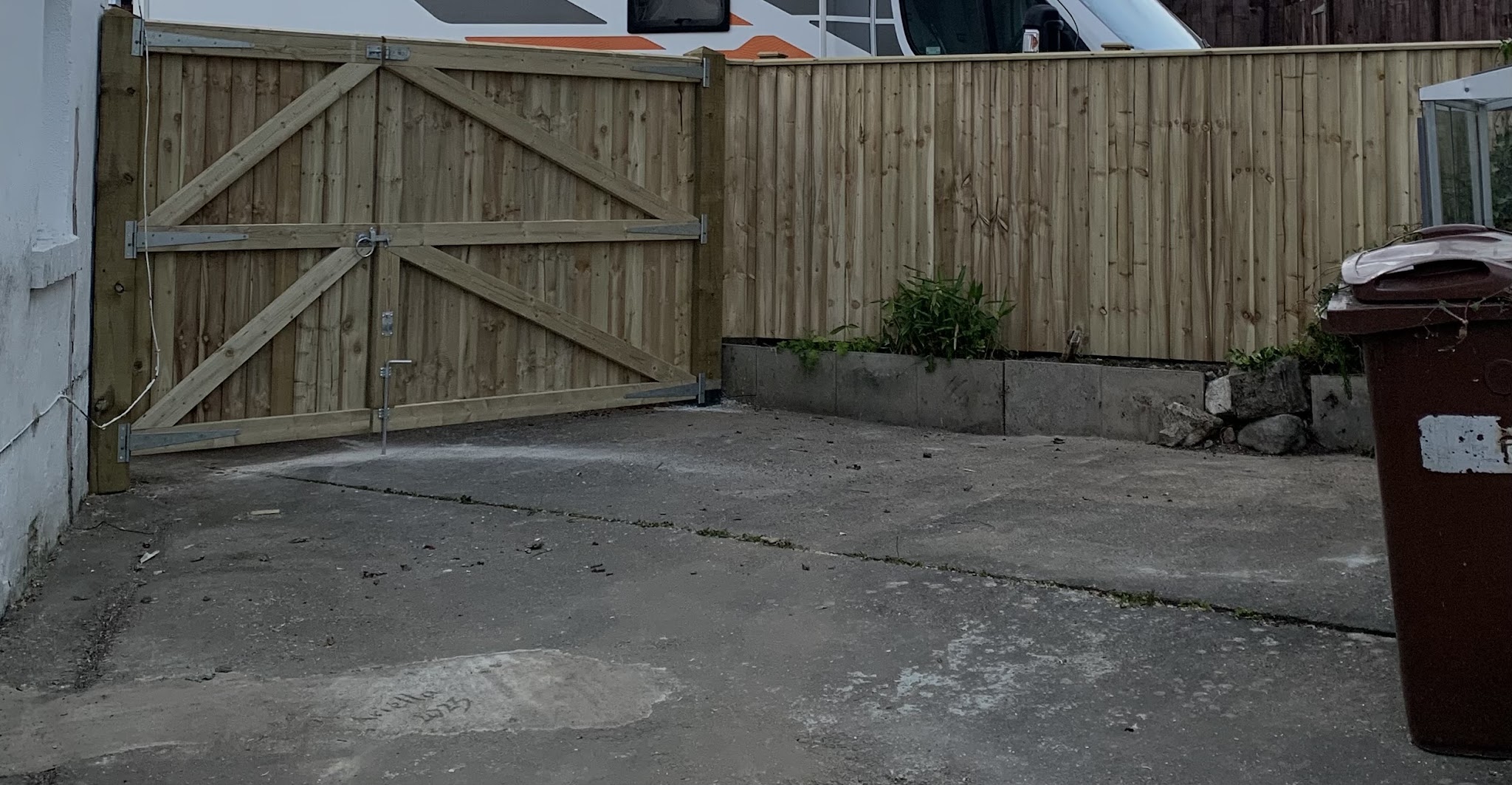A completed timber garden gate with matching fence panels